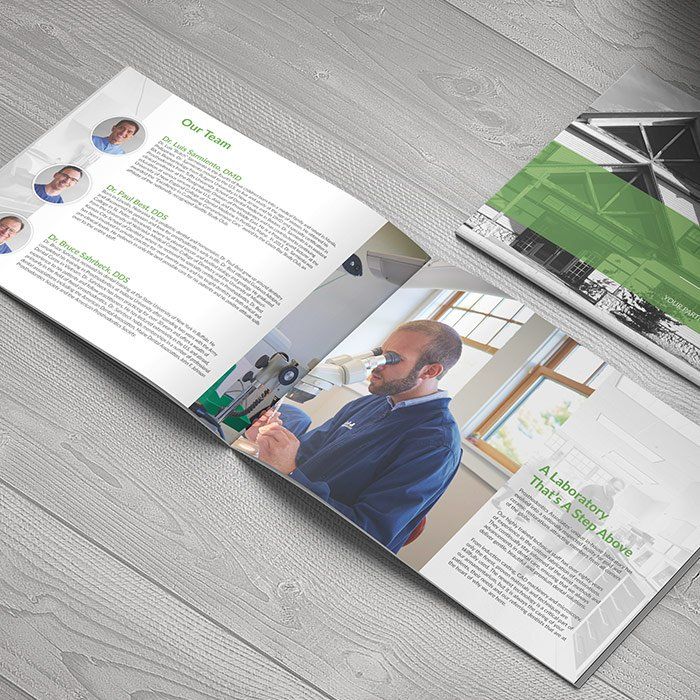 A book is open to a page with a man looking through a microscope