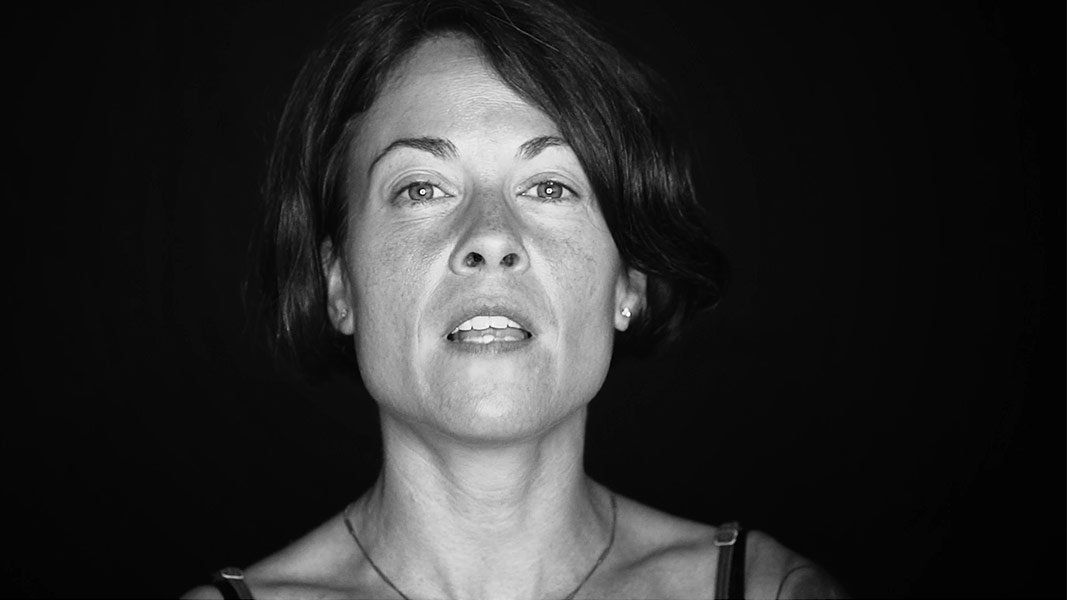 A woman is making a funny face in a black and white photo.