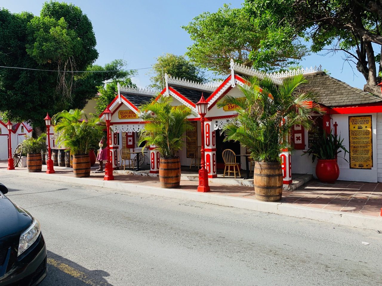 A car is parked in front of a red and white building