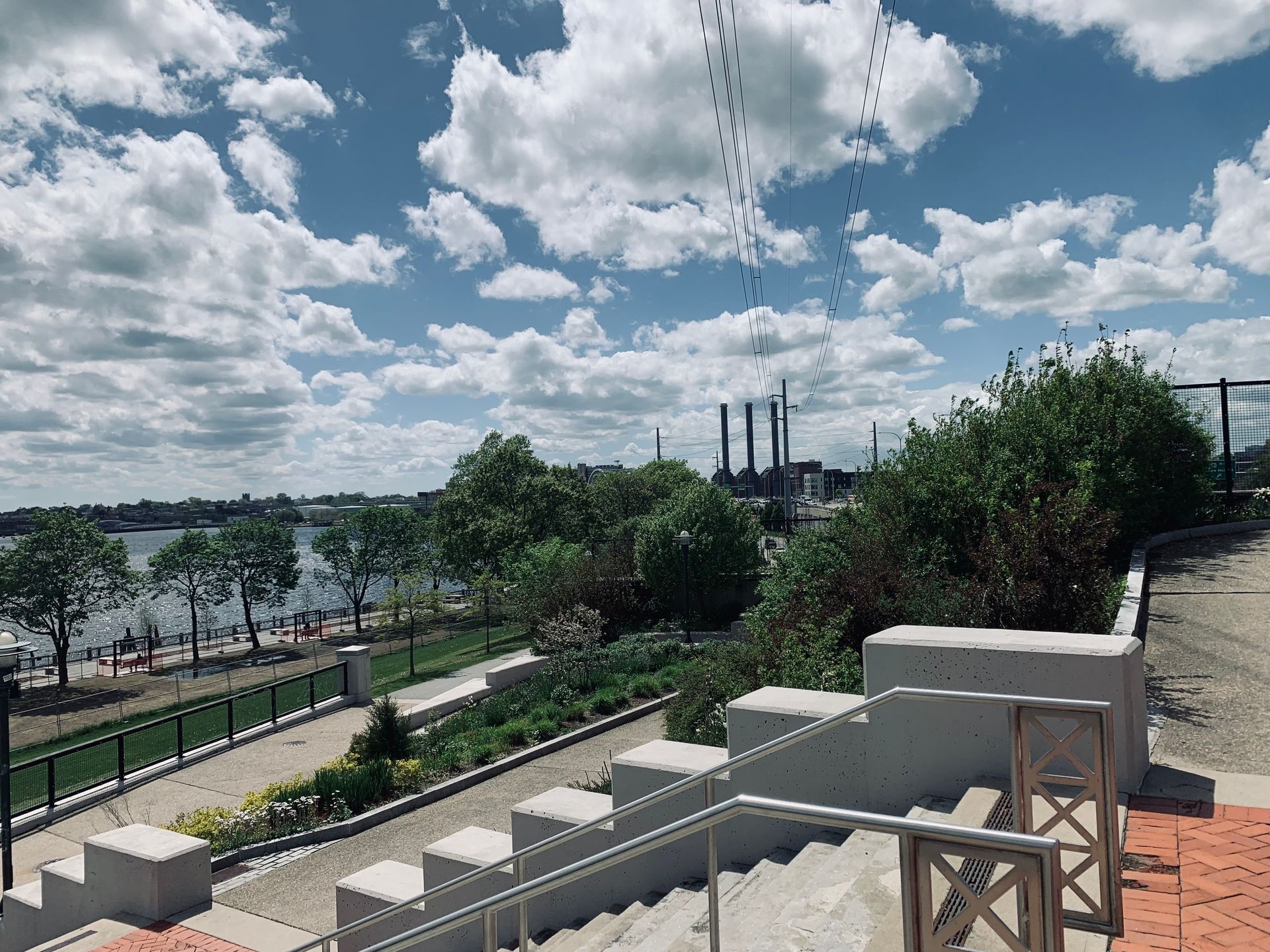 A view of a river from a staircase with a railing