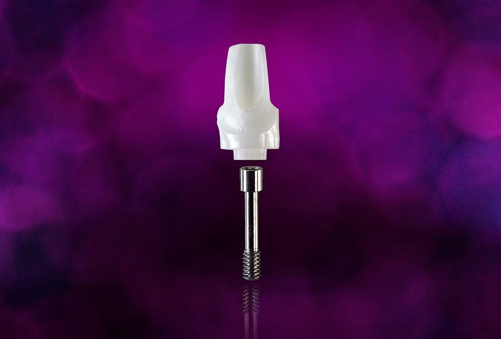 A white dental implant is sitting on a purple background.