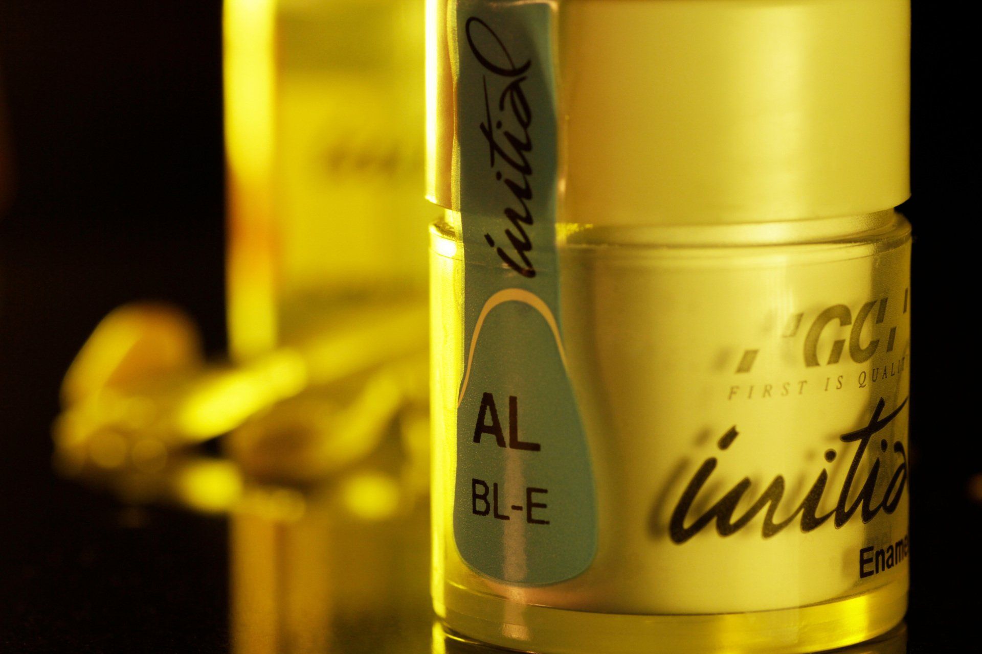 A close up of a bottle that says initial on it