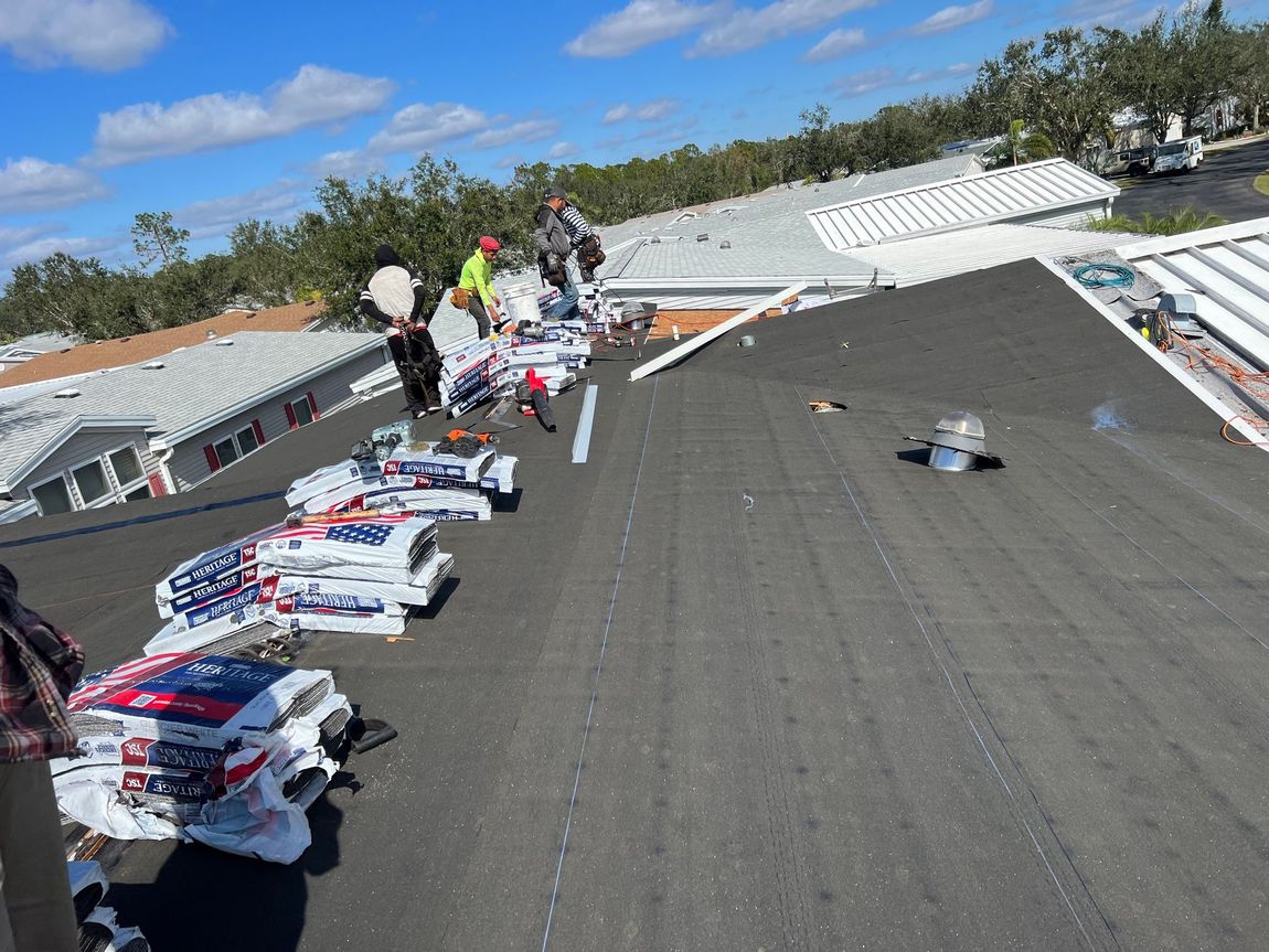 A group of people are working on the roof of a building