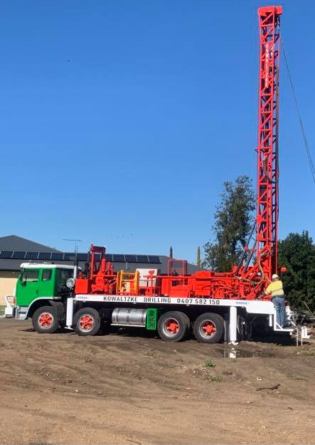 Drilling Truck Next To Worker — Drilling in Highfields, QLD