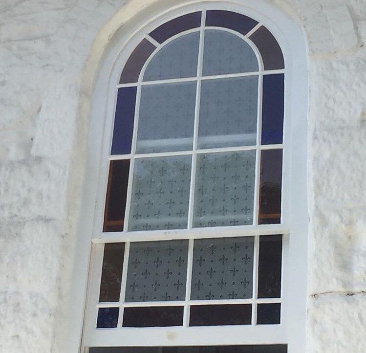 Arched stained glass sash window
