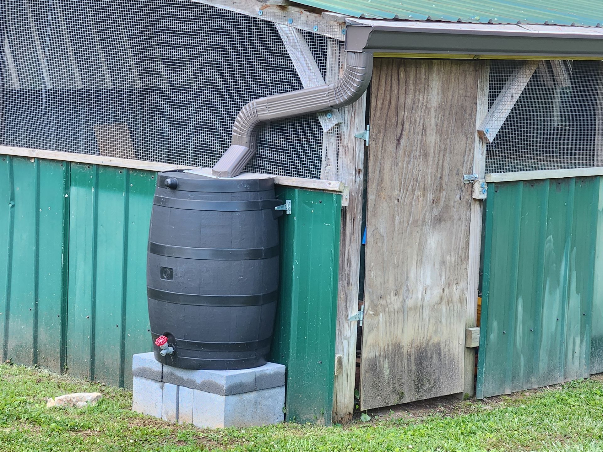 A close up of a black gutter on the side of a house.