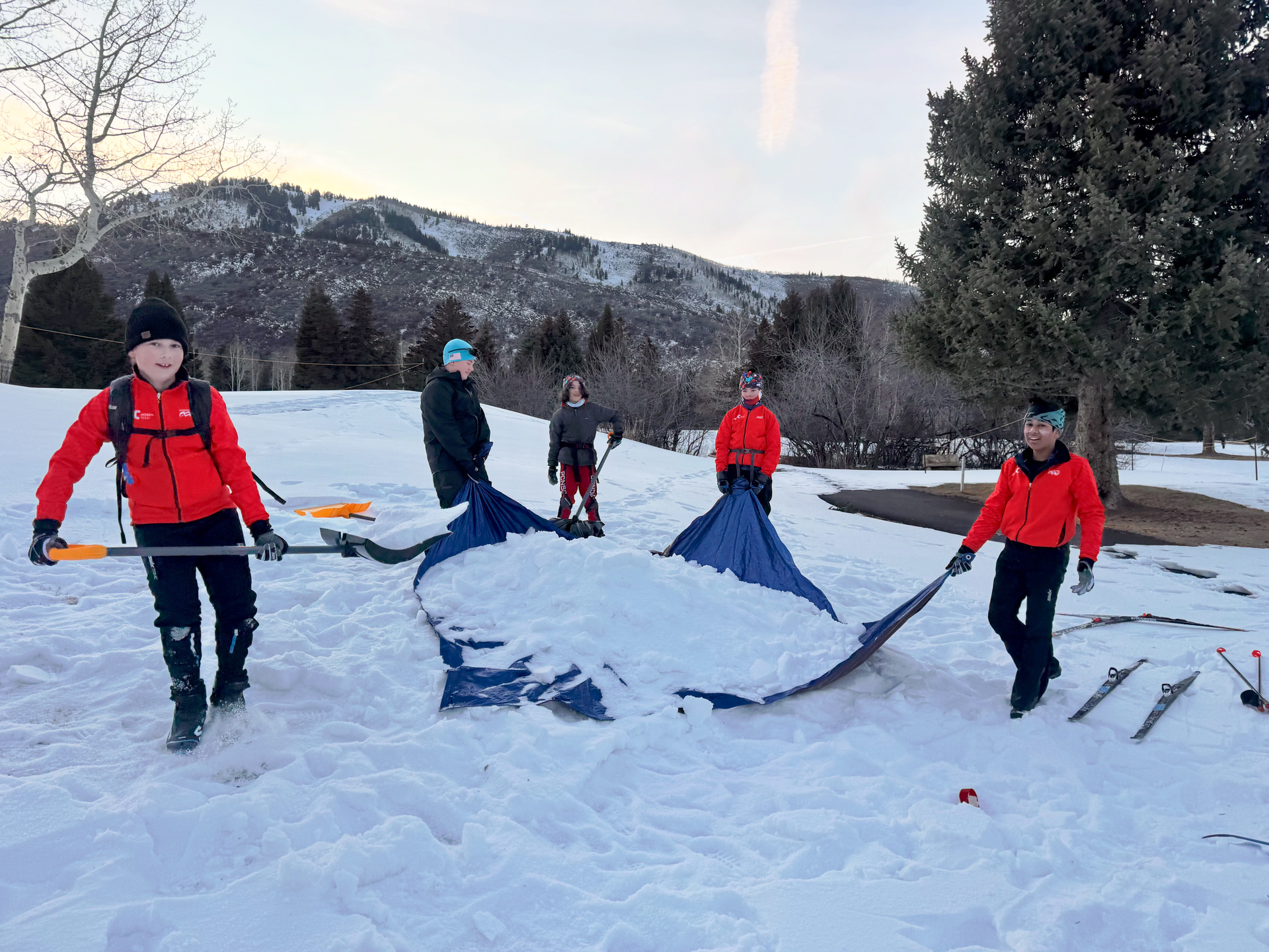 The Devo team shovels snow at White Pine to help keep the 3k open.