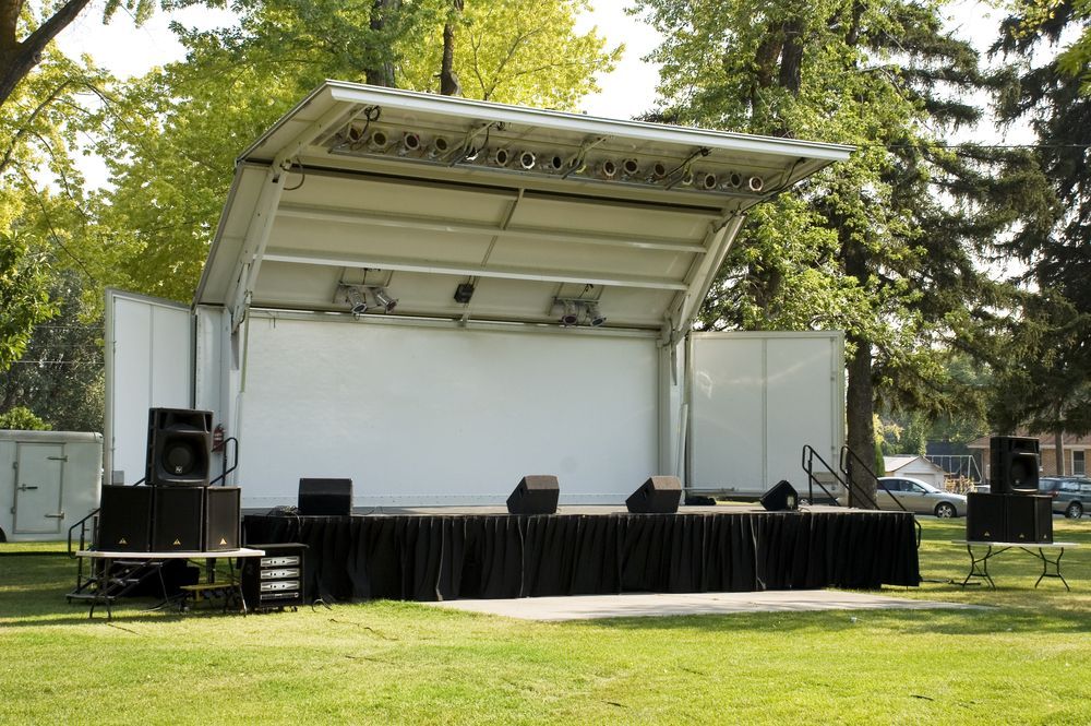 Outdoor Stage In A Park With Audio Equipment — Kennedy Amplifier Hire Service In South Mackay, QLD