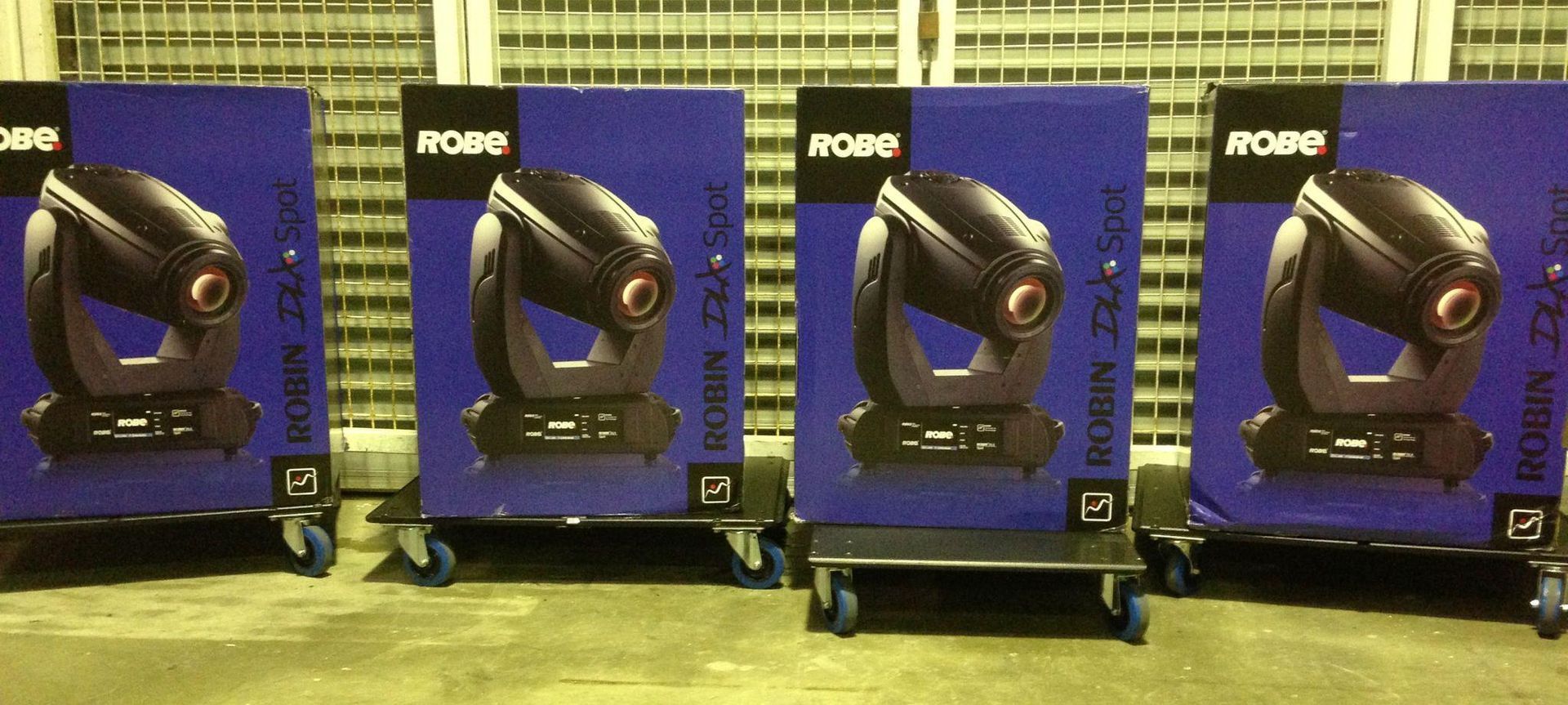 Four Blue Boxes With Stage Lights, Each On A Rolling Cart — Kennedy Amplifier Hire Service In South Mackay, QLD