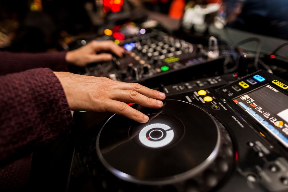 Dj's Hands On Turntable And Mixing Console With Lights — Kennedy Amplifier Hire Service In South Mackay, QLD