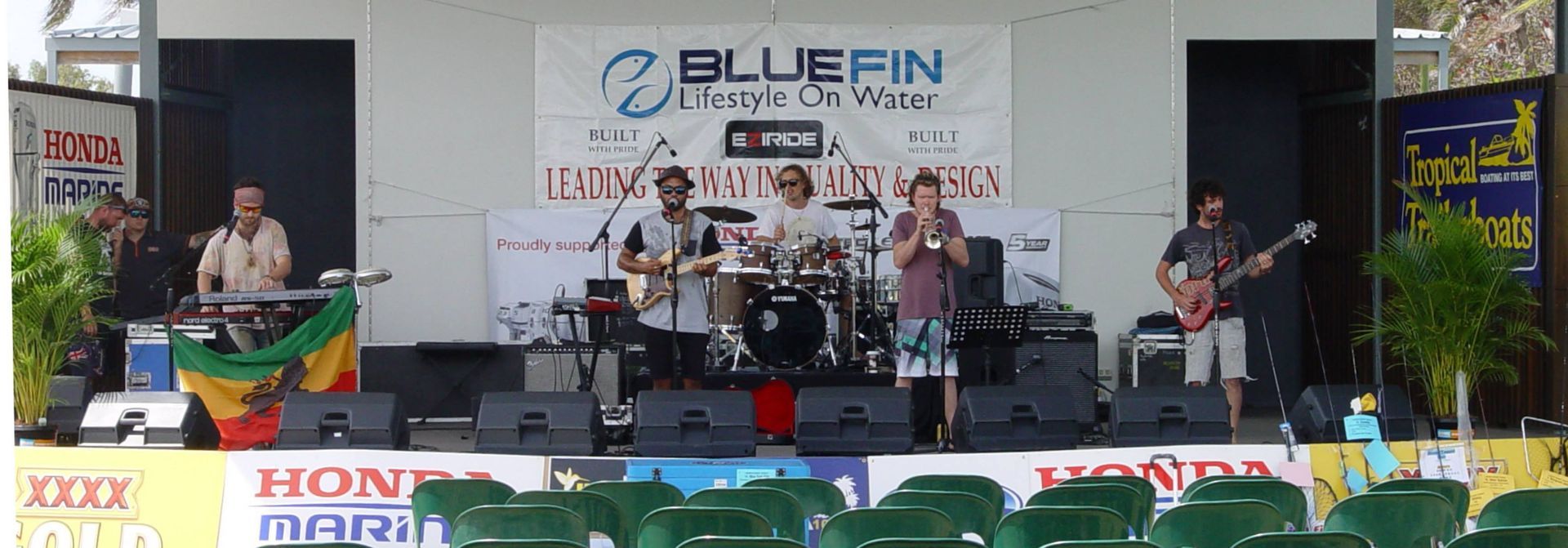A Band Performs On An Outdoor Stage At An Event — Kennedy Amplifier Hire Service In South Mackay, QLD