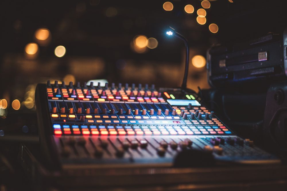 Sound Mixing Console With Illuminated Controls in a Dark Setting — Kennedy Amplifier Hire Service In South Mackay, QLD