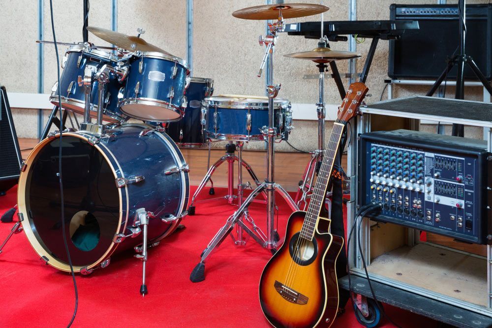Acoustic Guitar Leans Against A Cart With A Mixing Board — Kennedy Amplifier Hire Service In South Mackay, QLD