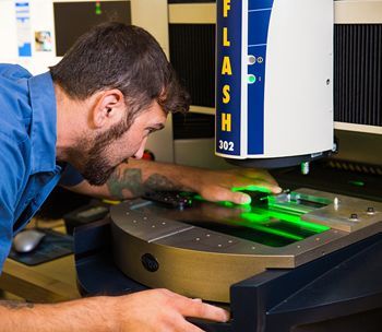 A man is working on a machine that says flash 302