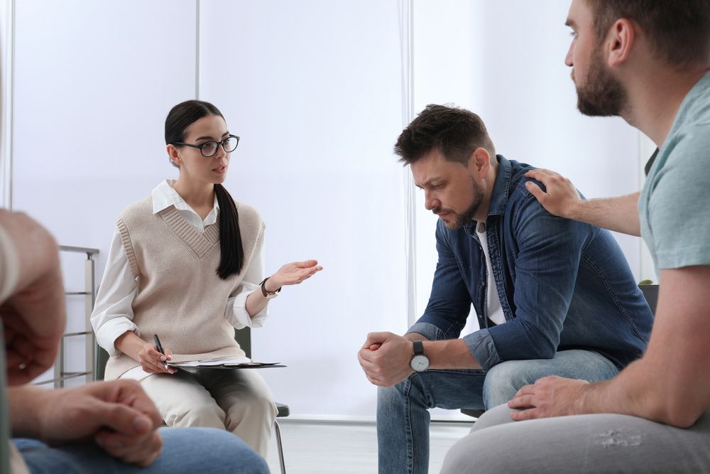 Therapist and Group Members in a Support Session — The Red Chair Therapy in Blackwall, NSW