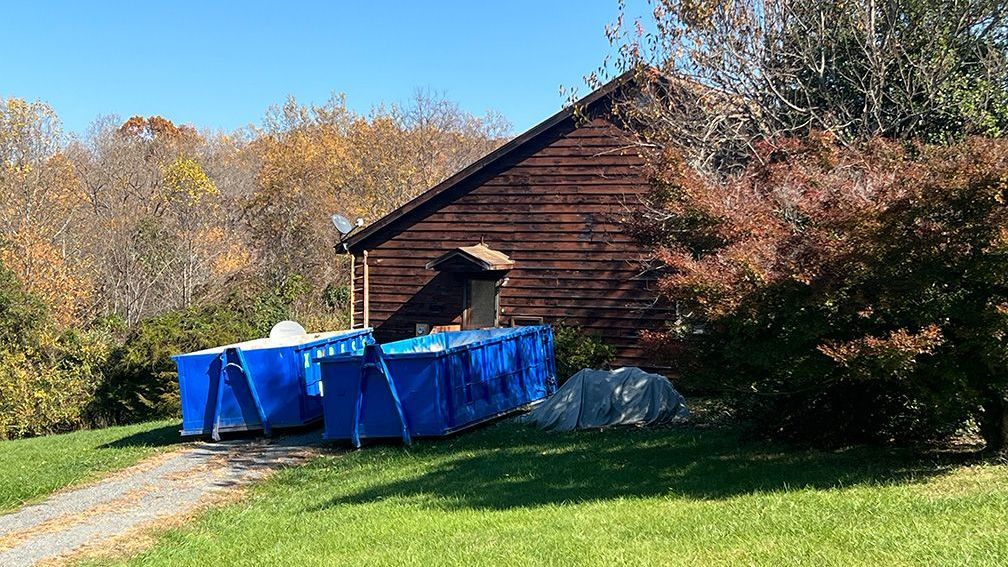 Large roll-off dumpster from Xpress Dumpster Rentals being used for a residential cleanout in Culpeper, VA.