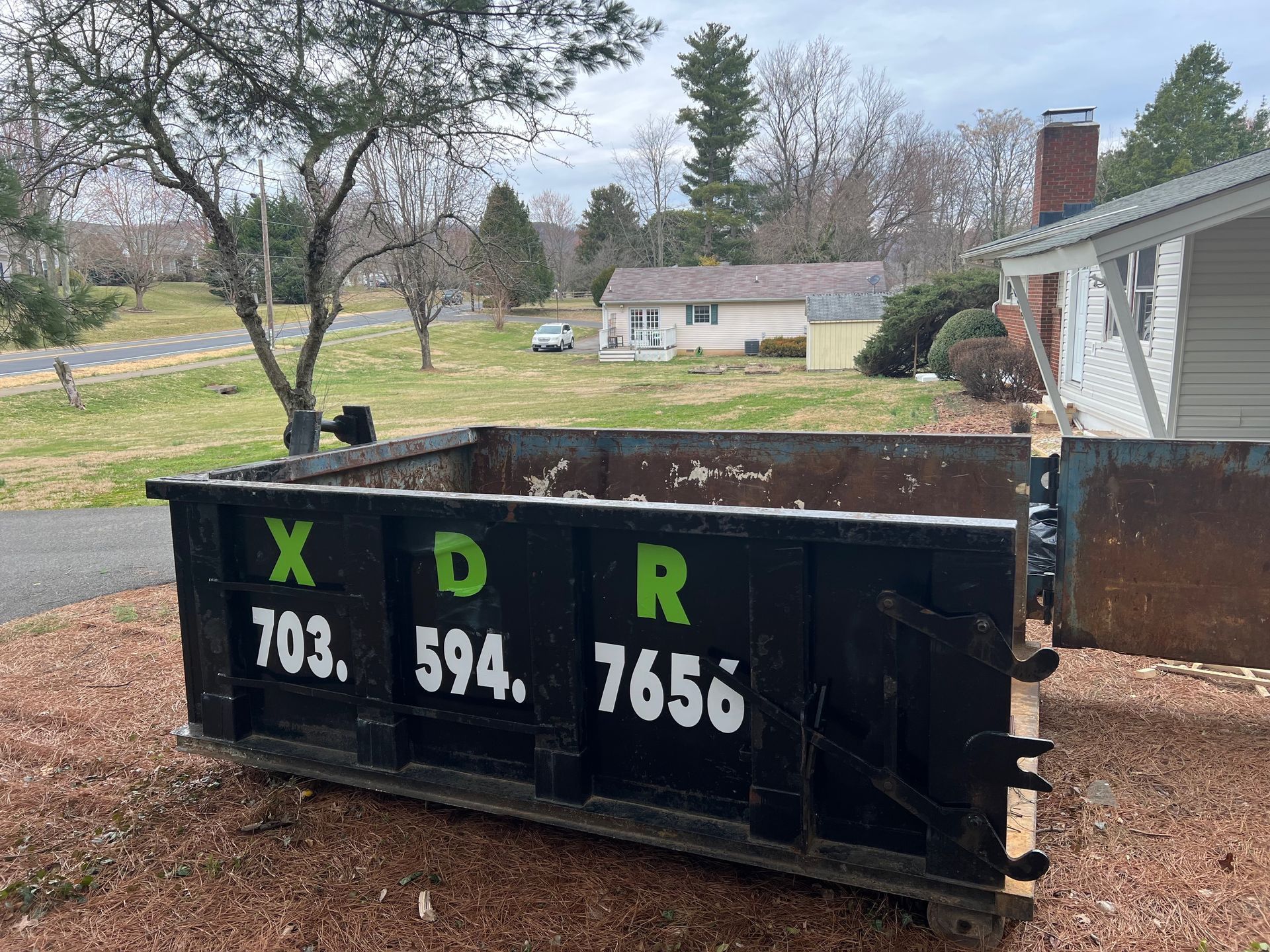 An empty 10 yard dumpster with its doors open in Marshall, VA., ready to be filled with debris