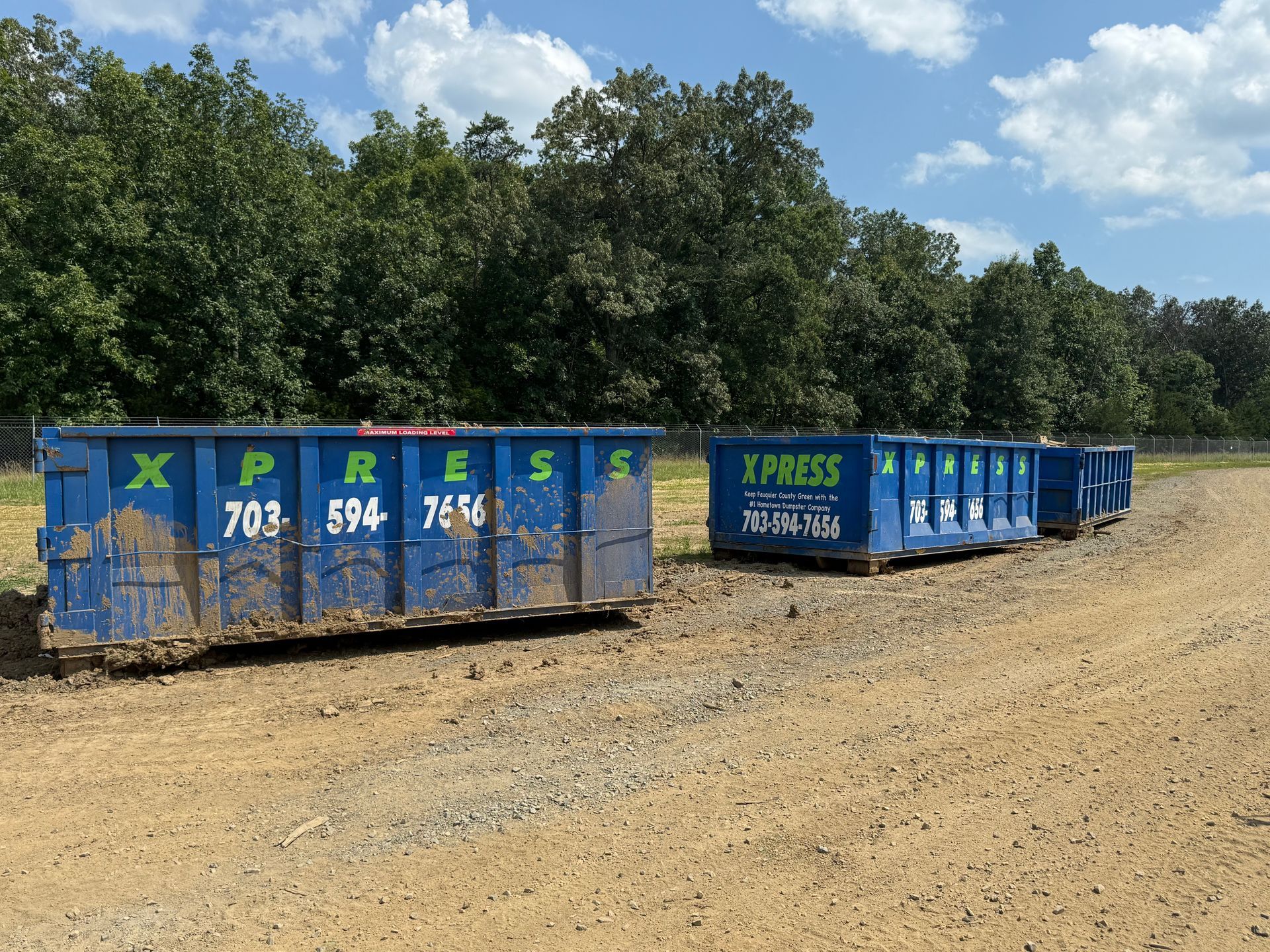 Contractor loading construction debris into 30-yard roll-off dumpster in Gainesville VA