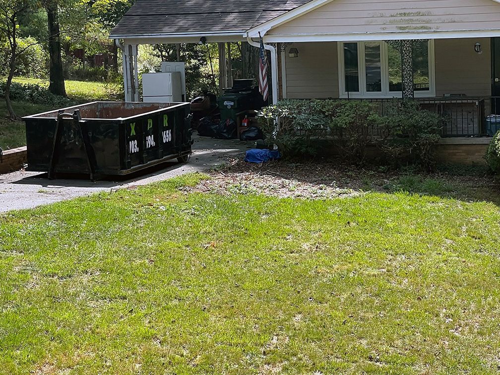 A 10 yard dumpster placed in a residential driveway in Nokesville, VA., suitable for home renovation projects.