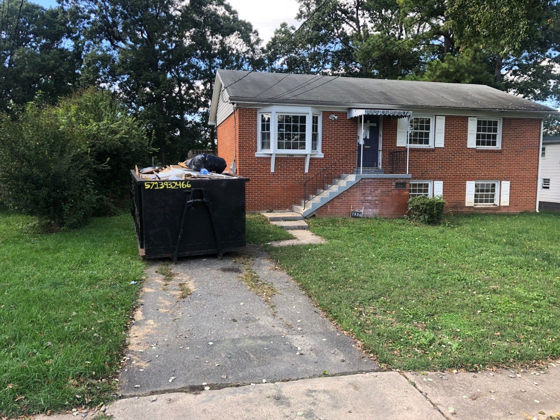 Dumpster rental in Manassas VA with hook-lift truck placement by Xpress Dumpster Rentals