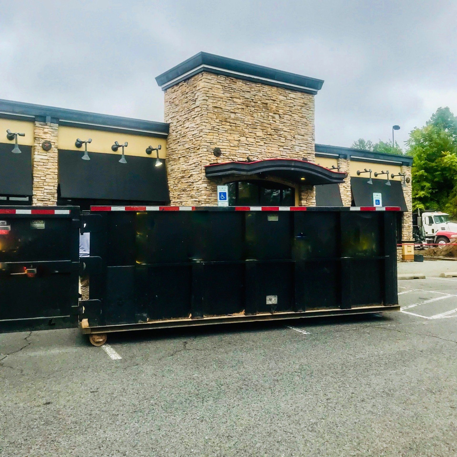 a large dumpster is parked in front of a building