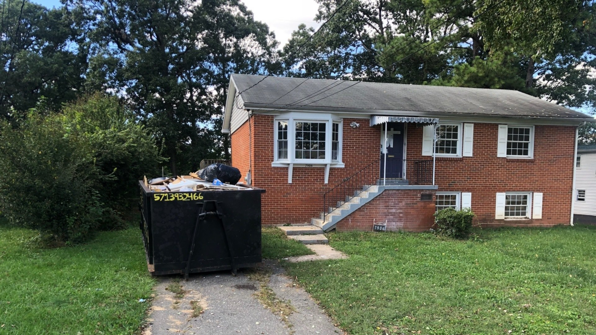 Dumpster rental in Manassas VA with hook-lift truck placement by Xpress Dumpster Rentals