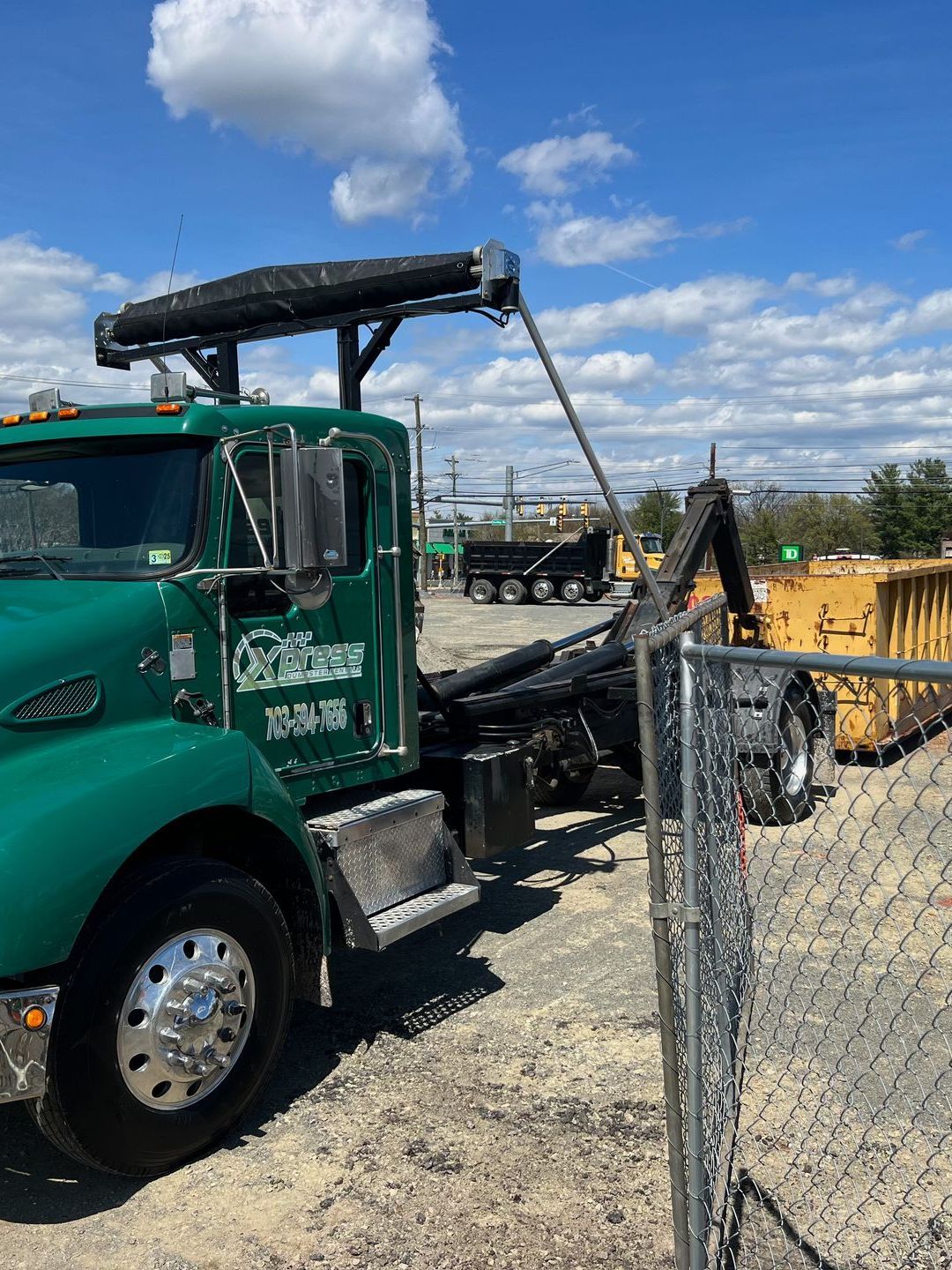 Xpress Roll-Off Dumpster Truck Delivering a 30 Yard Dumpster