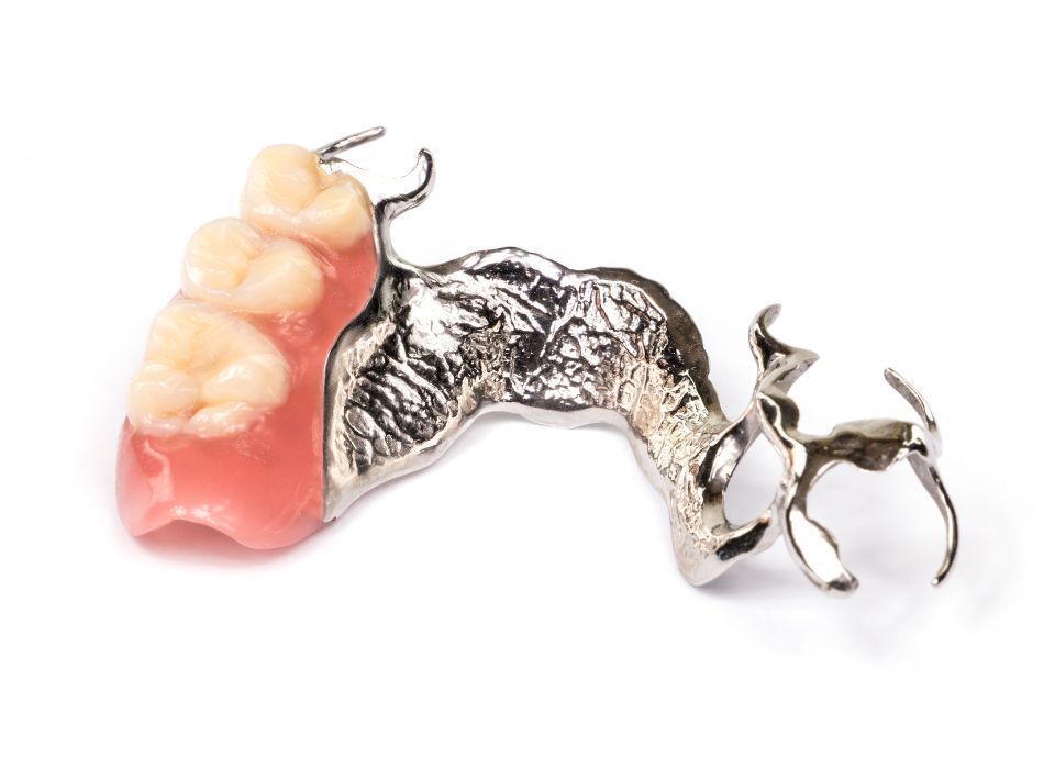 Set of dentures, upper and lower, with pink gum-like base and white teeth.