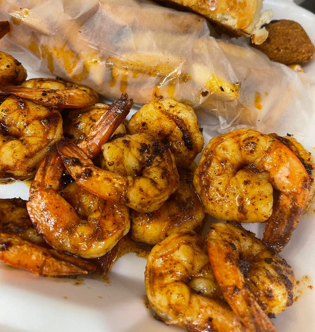 A close up of a plate of shrimp on a table.