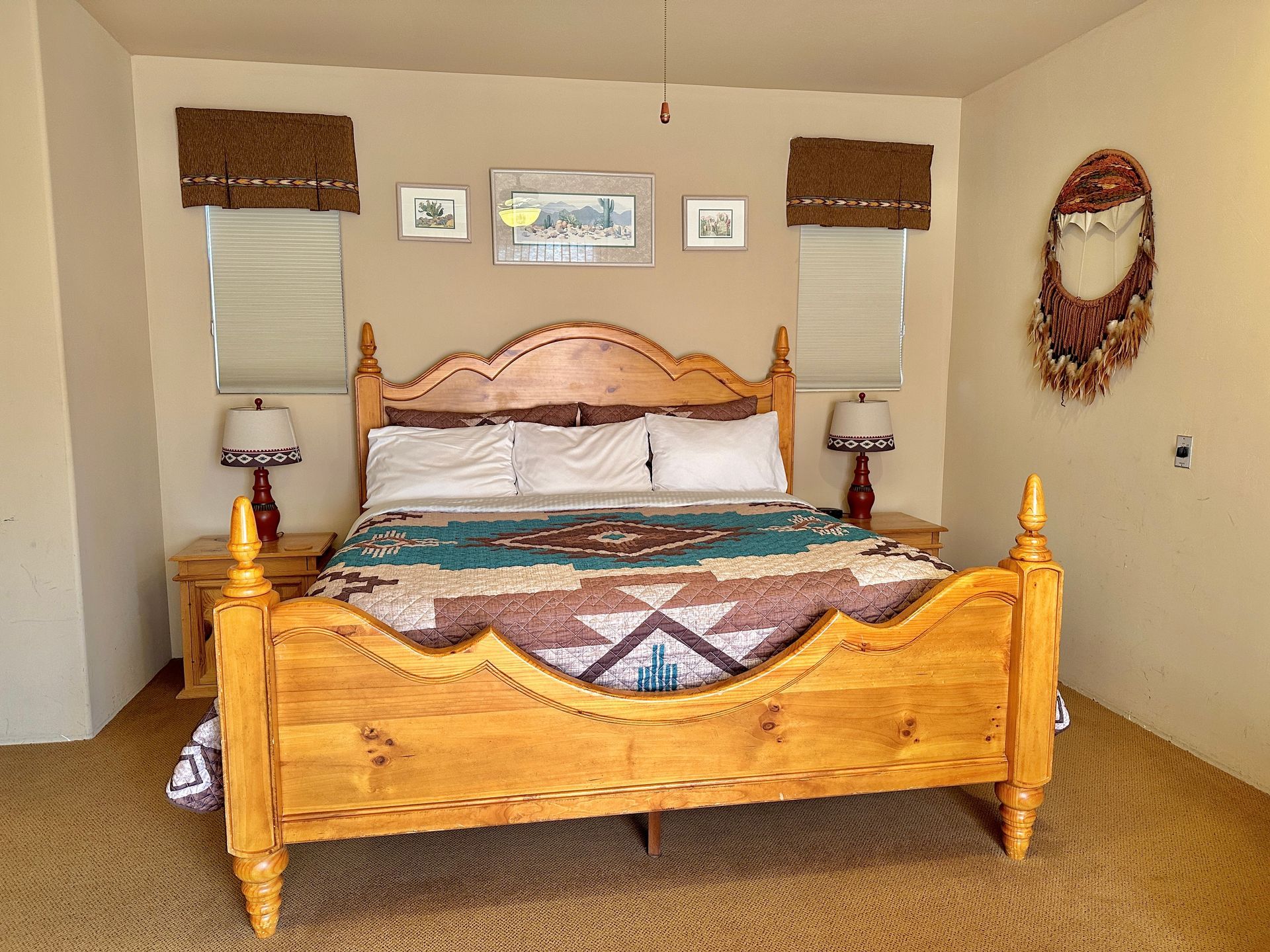 A bedroom with a wooden bed and two lamps.