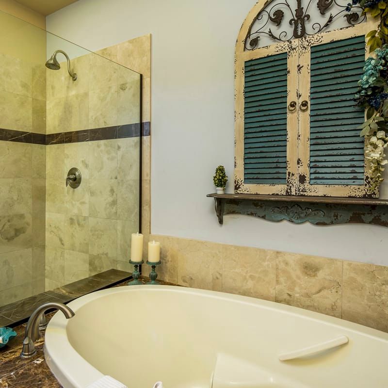 A bathtub in a bathroom next to a shower