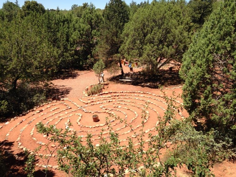 An aerial view of a labyrinth in the middle of a forest.