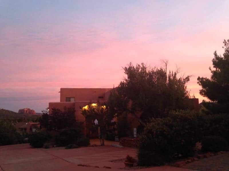 A house with a pink sky in the background