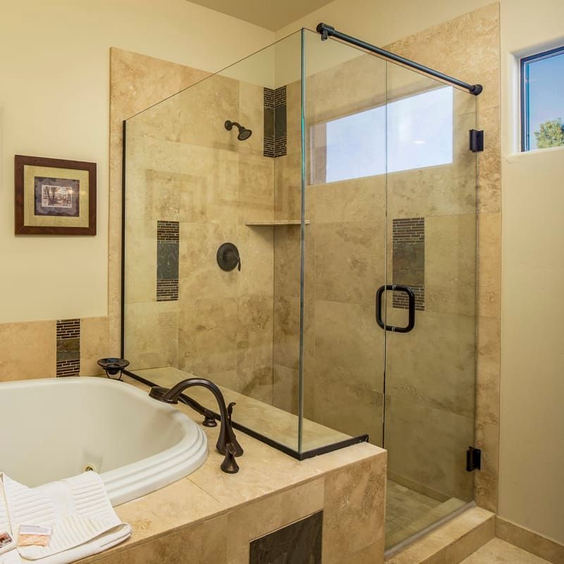 A bathroom with a bathtub and a walk in shower