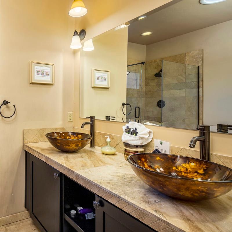 A bathroom with two sinks and a large mirror