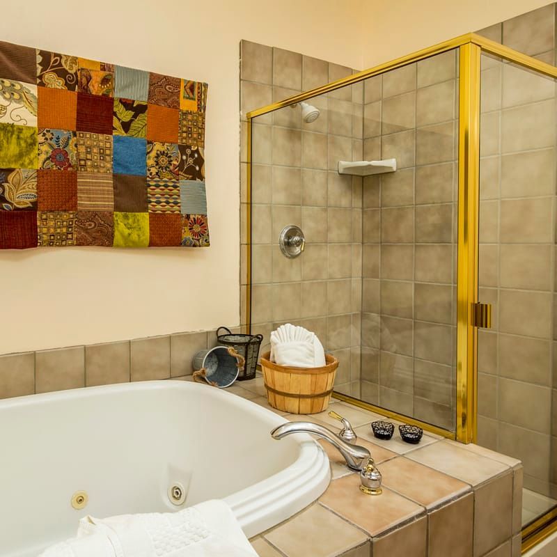 A bathroom with a jacuzzi tub and a shower