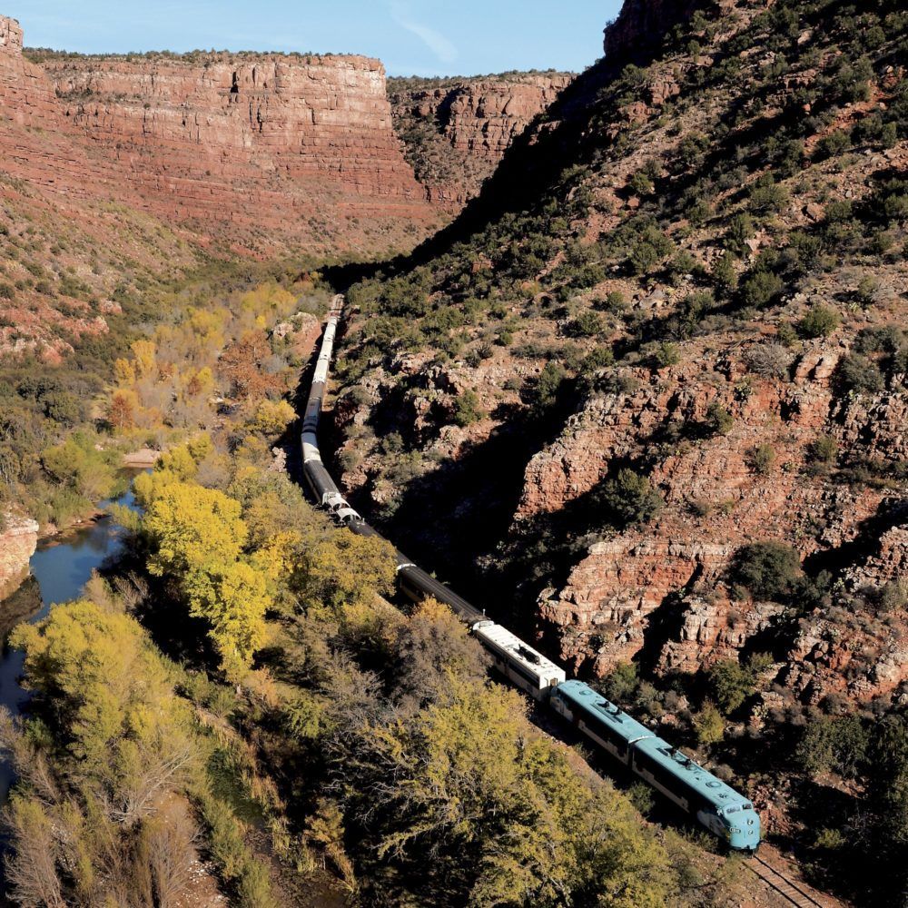An aerial view of a train traveling through a valley