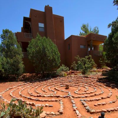 A large house with a labyrinth in front of it