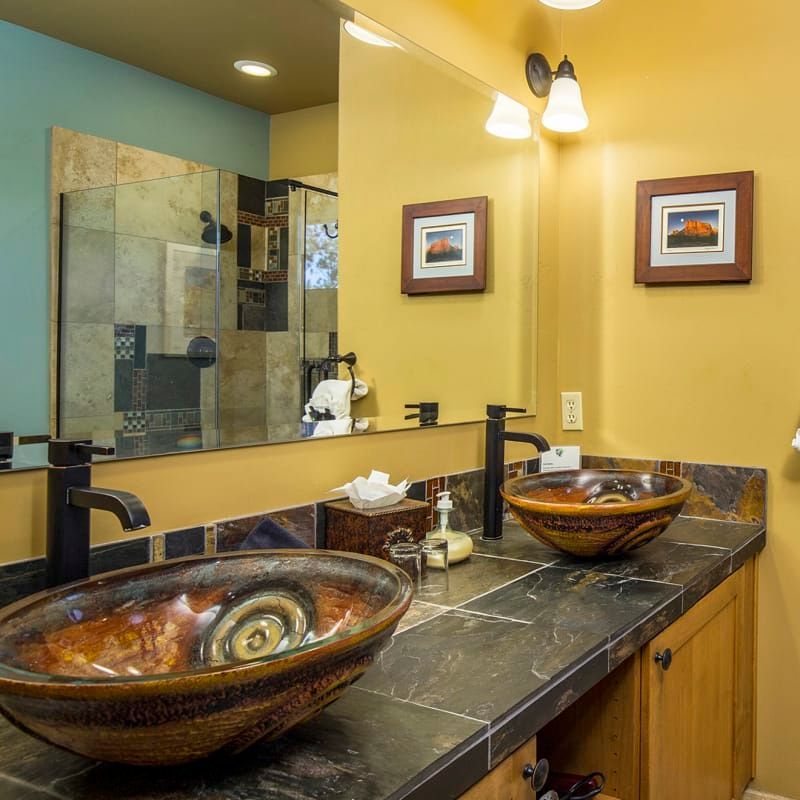 A bathroom with two sinks and a large mirror