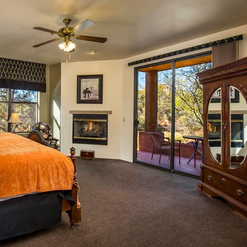 A bedroom with a king size bed and a fireplace