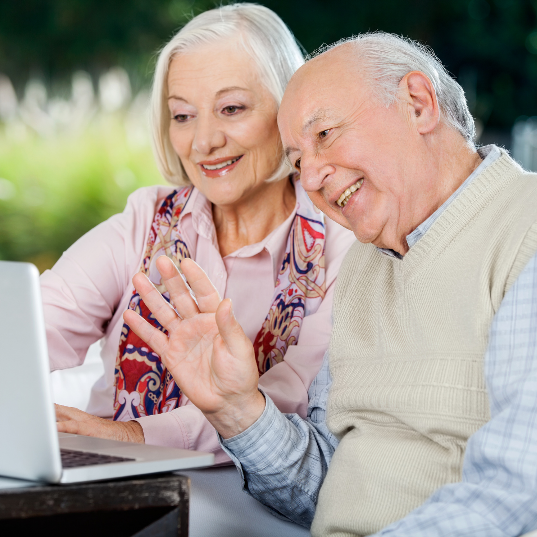 image of a older couple looking at their computer screen.