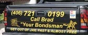 A man in a suit is wearing handcuffs.