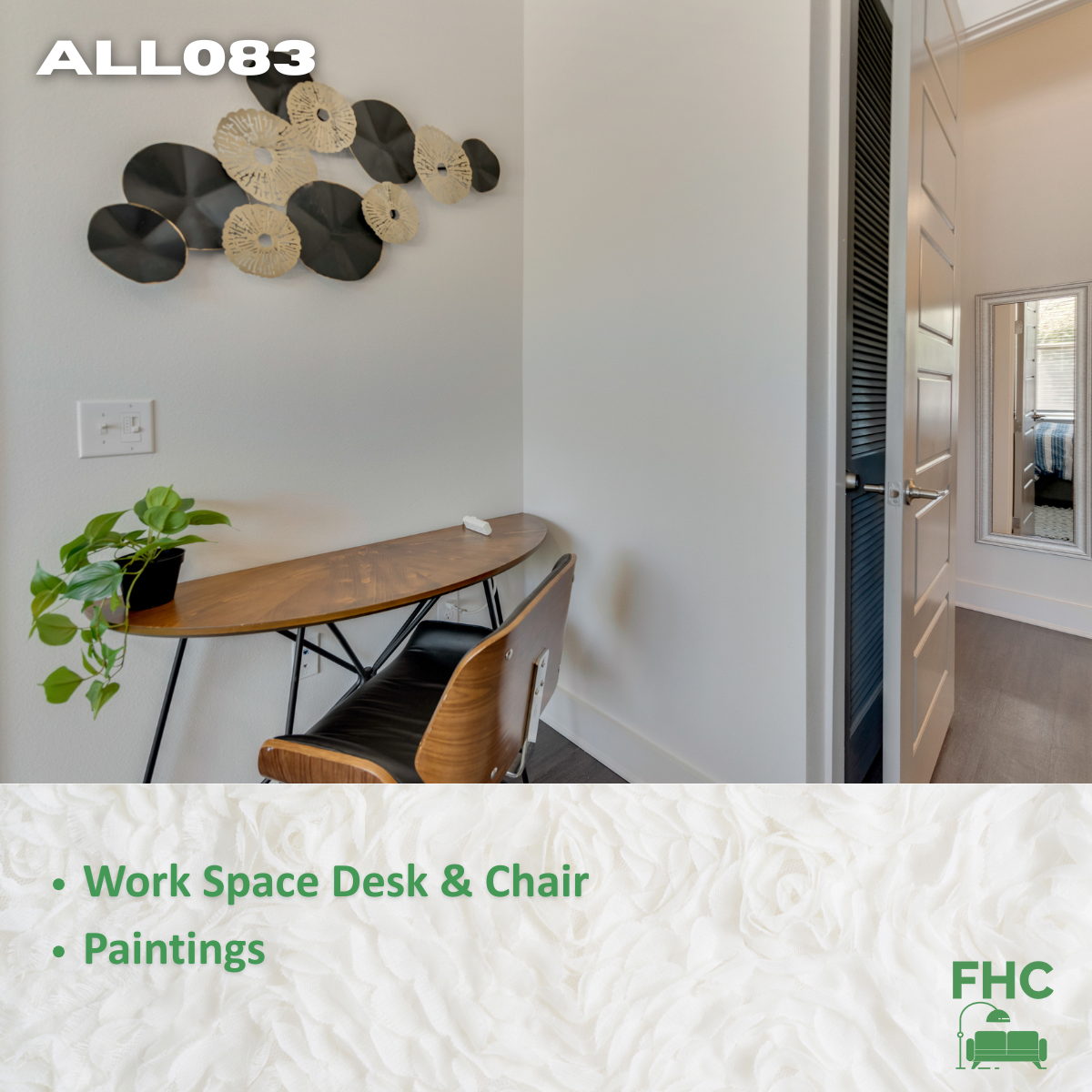 A work space desk and chair with paintings on the wall