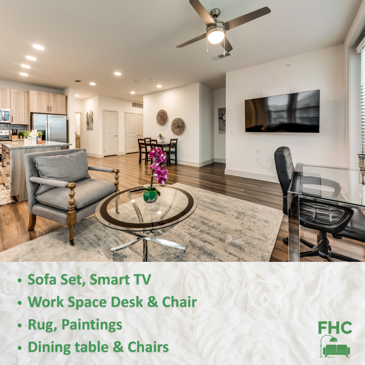 A living room with a couch smart tv work space desk chair rug paintings dining table and chairs