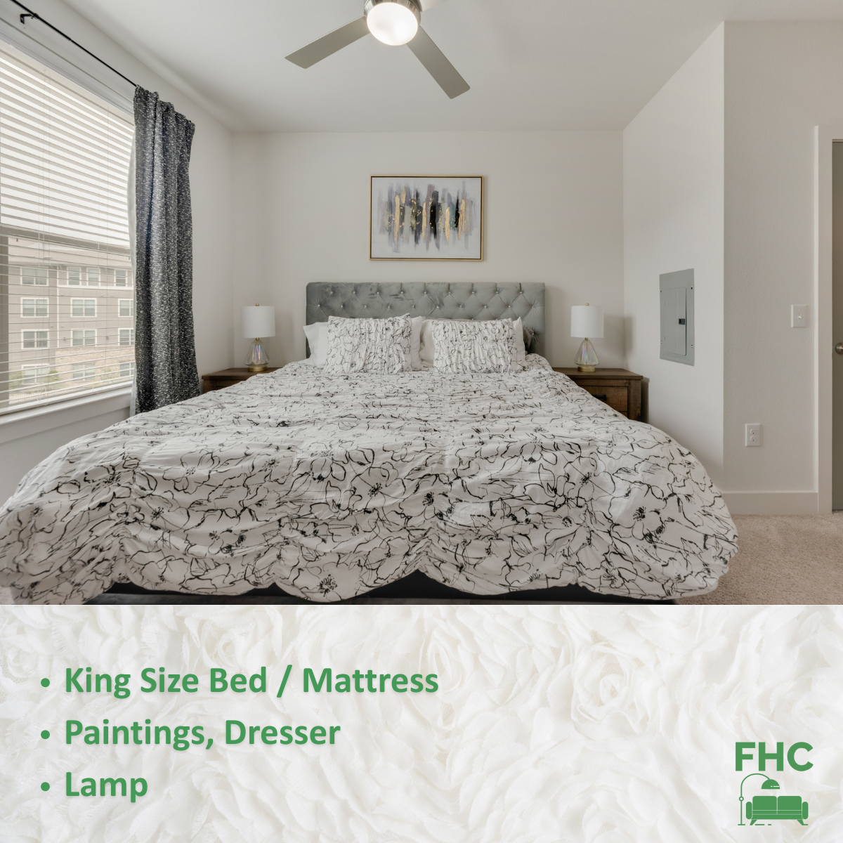 A bedroom with a king size bed and a ceiling fan