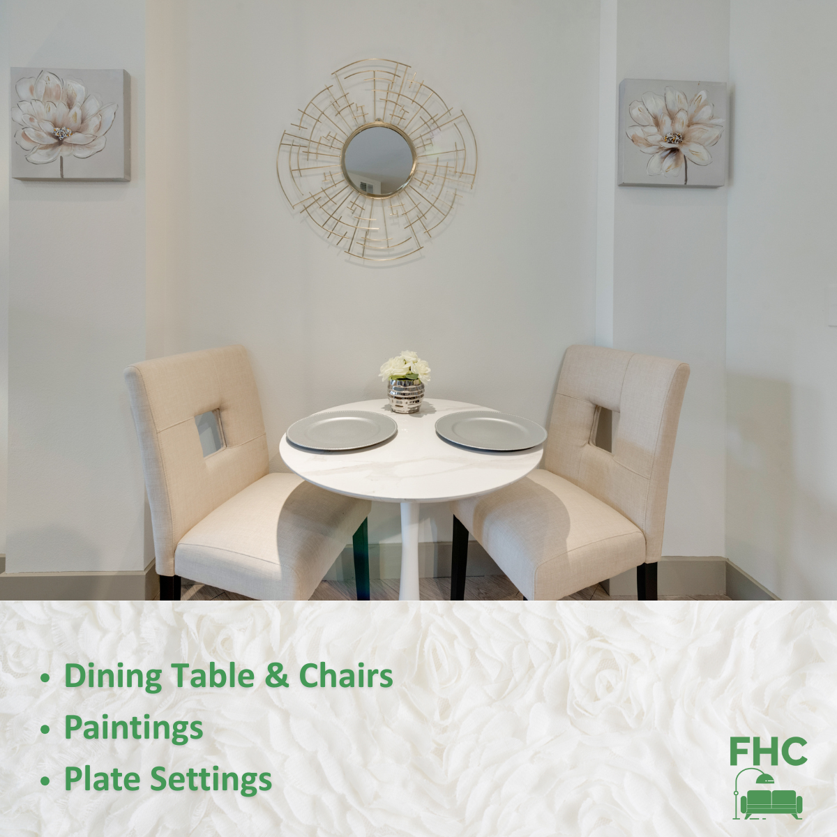 A dining table and chairs with paintings and plate settings