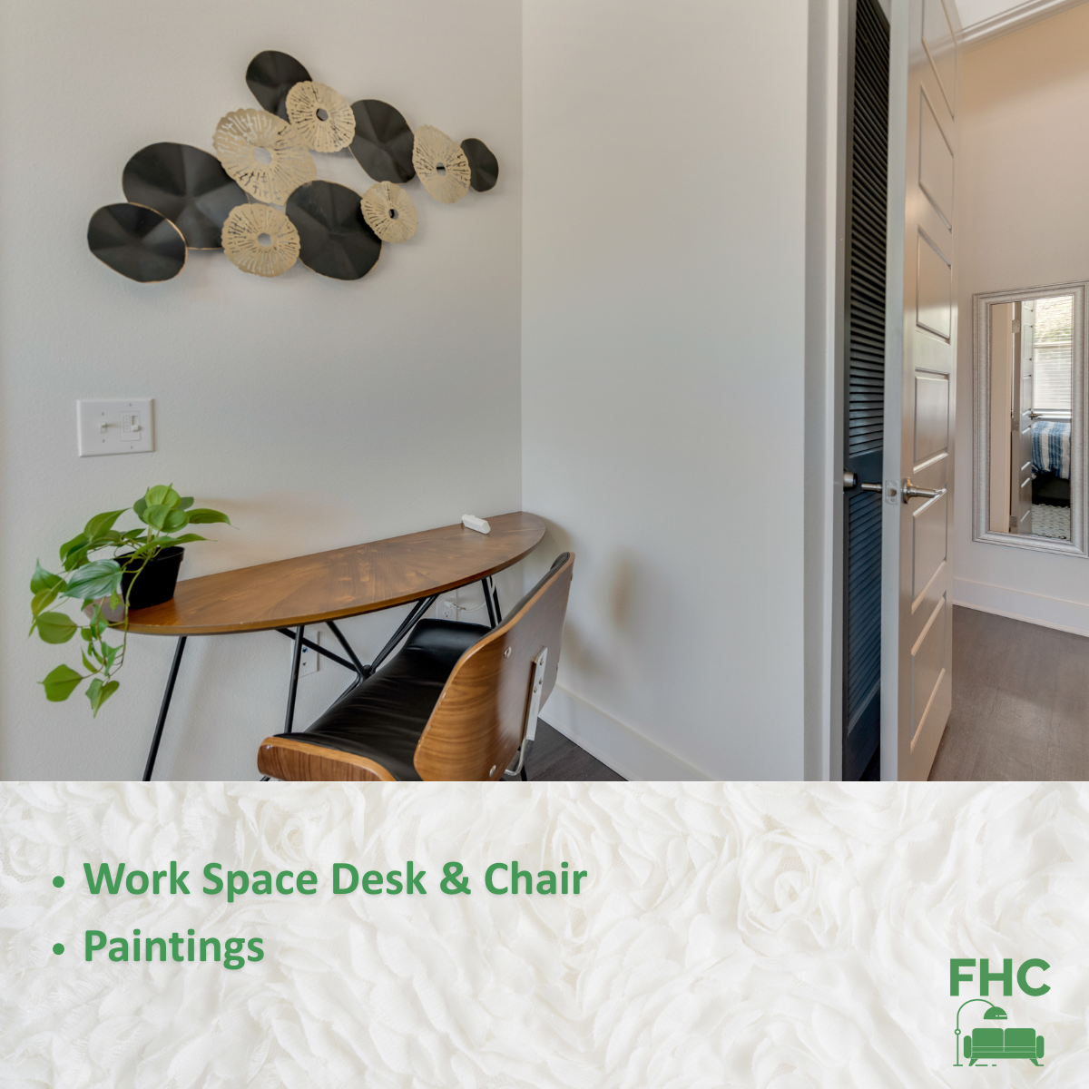 A work space desk and chair with paintings on the wall