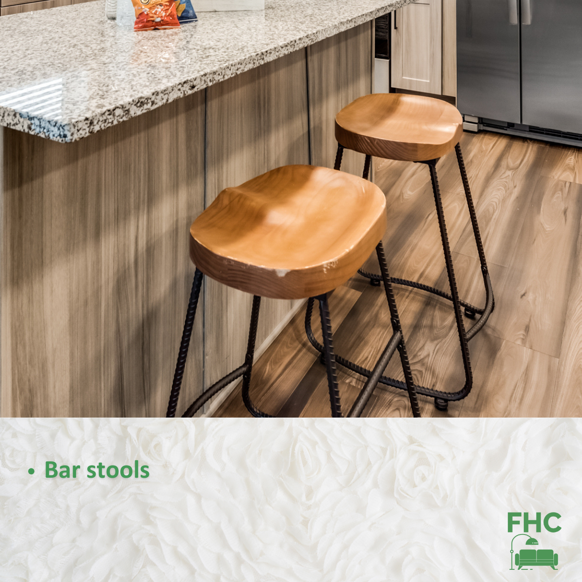 Two wooden bar stools in front of a granite counter top