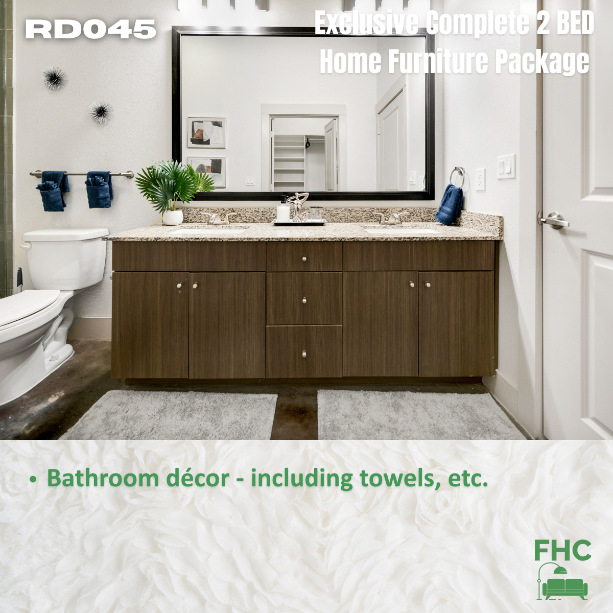 Bathroom with dark vanity, large mirror, and decorative towels.