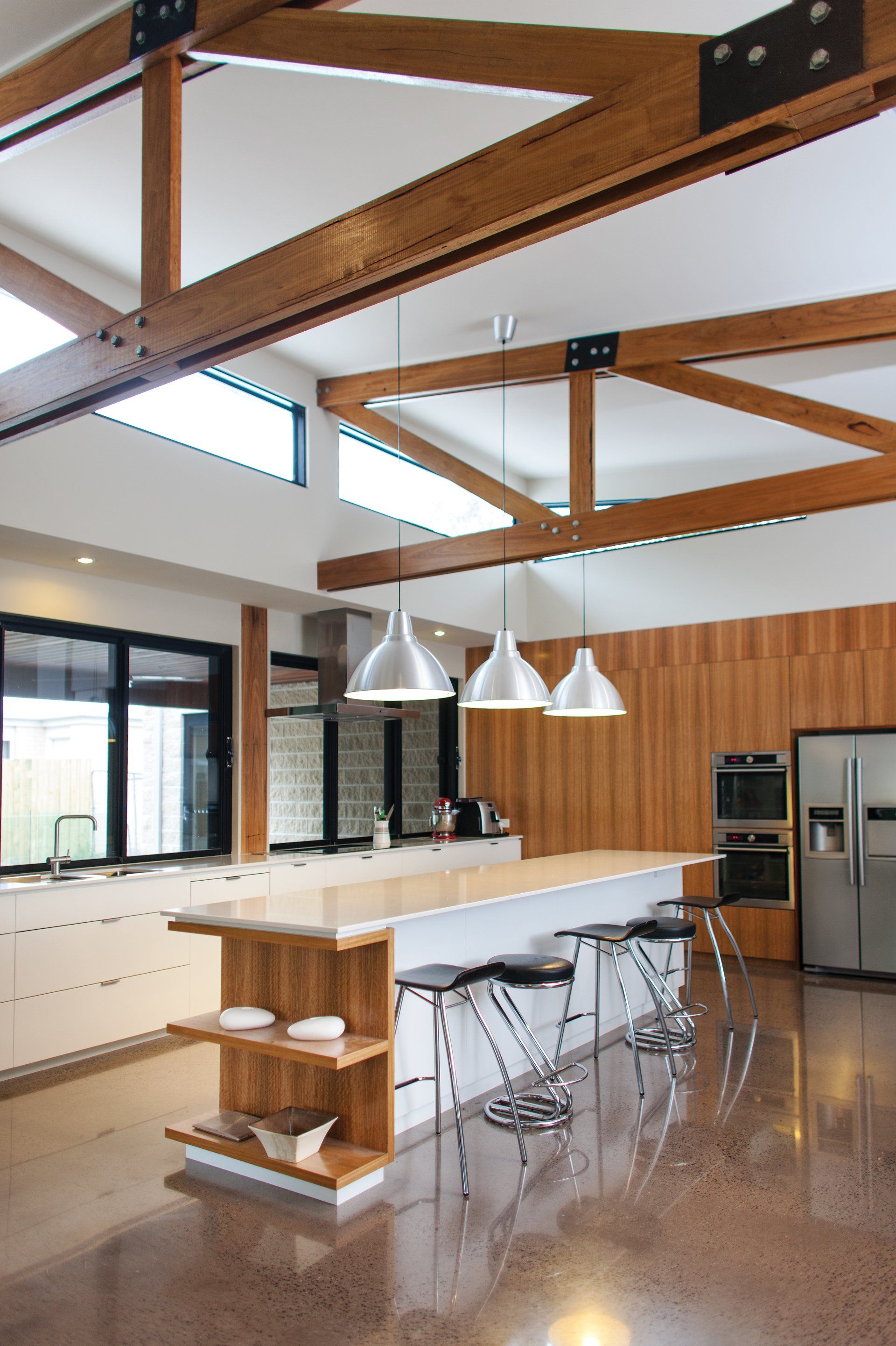 A kitchen with a large island and stools